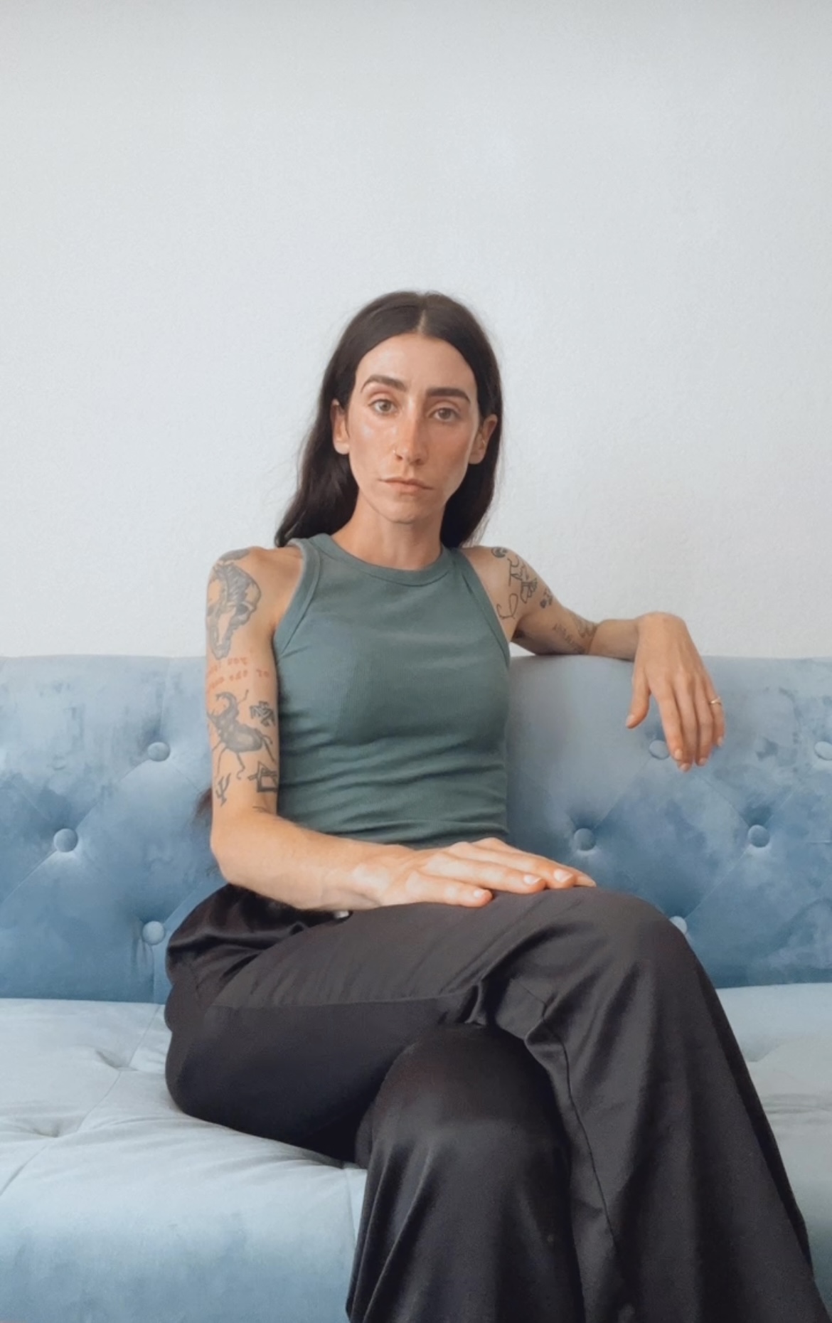 Picture of Lauren K. Dougherty, sitting on a pale blue couch.