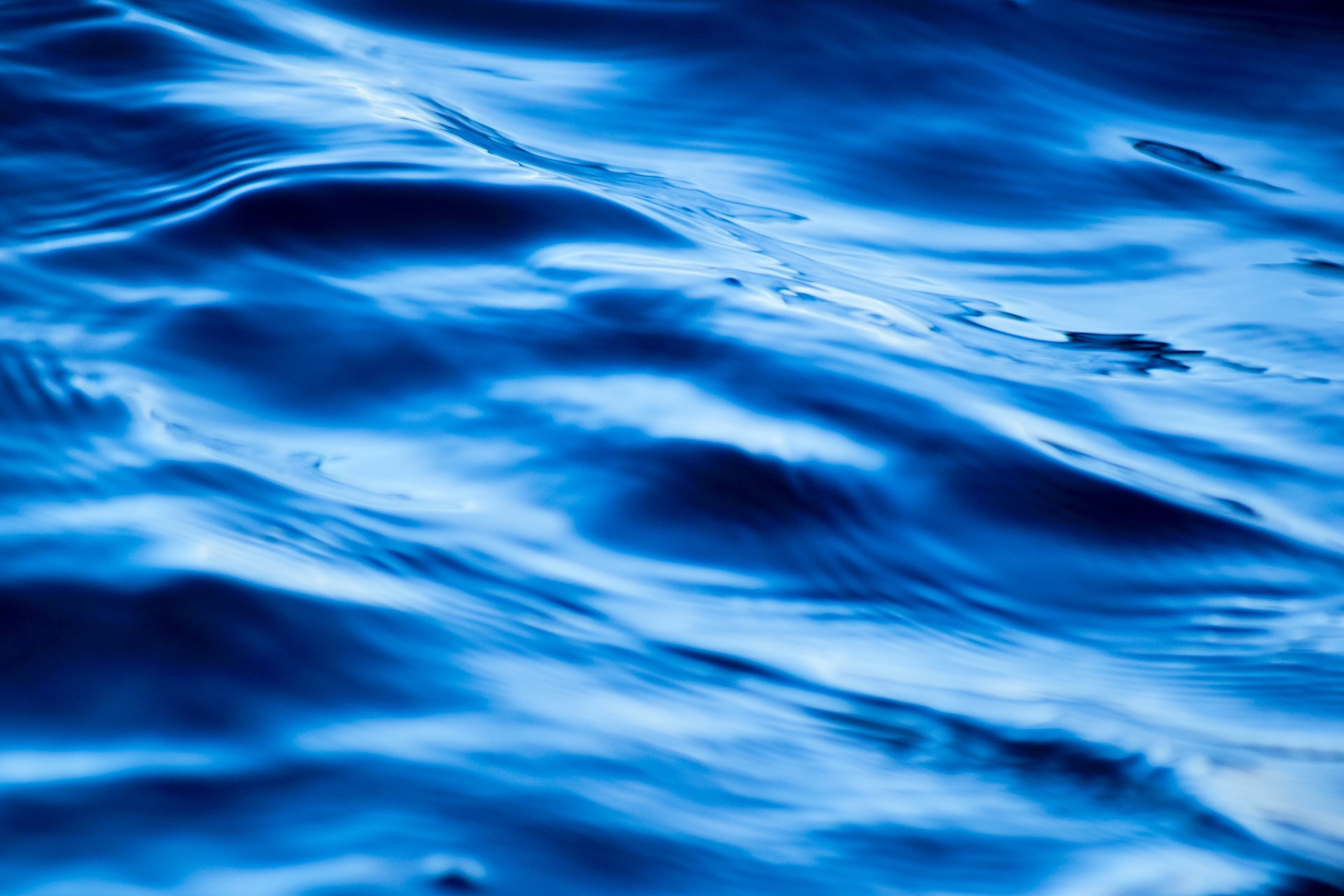 A close-up of ripples in bright blue water
