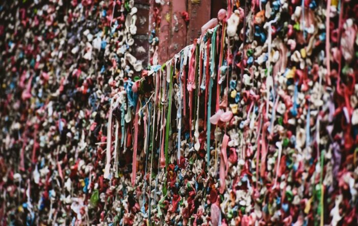 A wall covered in wads of chewed chewing gum